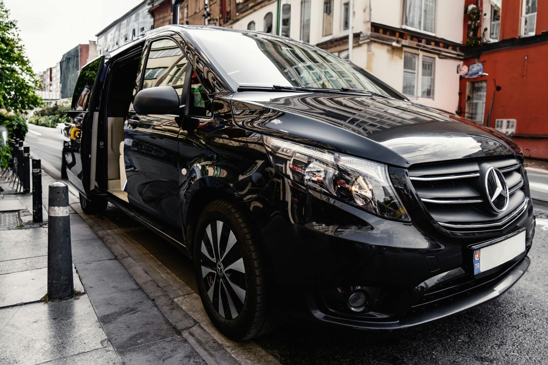 Black Mercedes V-Class parked by the Sidewalk with the Side Door Open